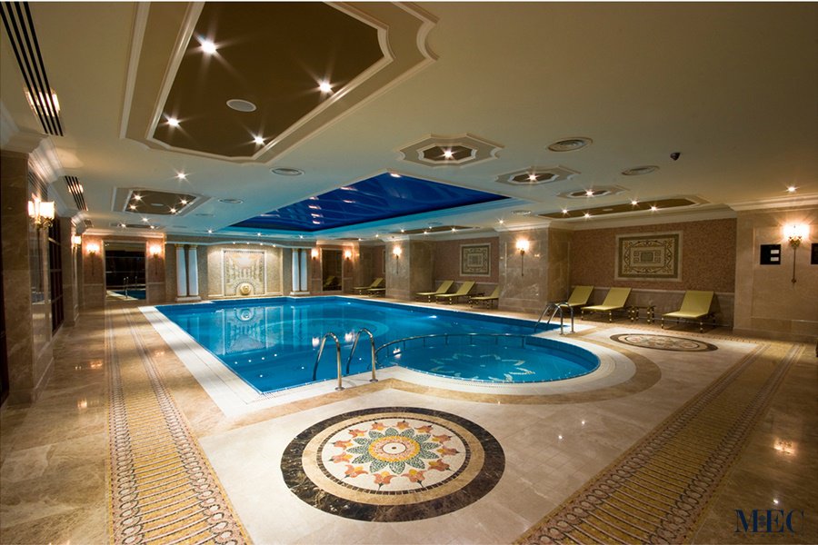 MEC Pools | Marble mosaic pool deck medallion and premium quality glistening glass tile mosaic swimming pool.
