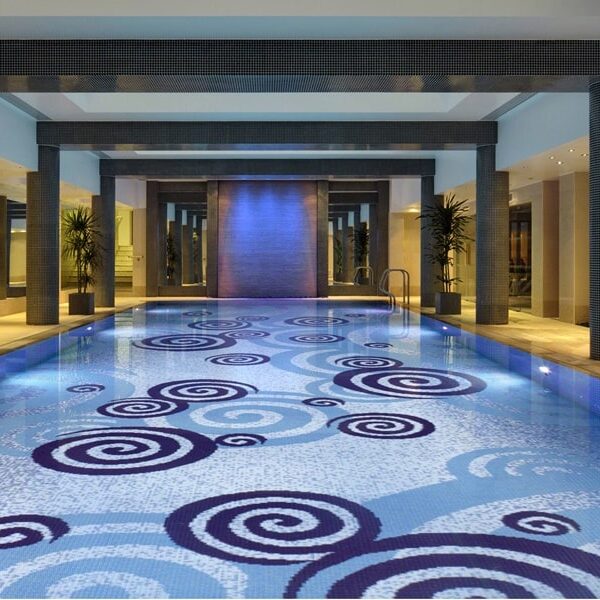 Luxury Pools by MEC | Spiral pool art made with sparkling glass mosaic tiles.