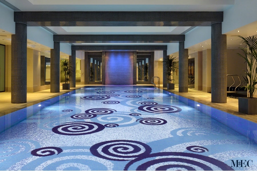 Luxury Pools by MEC | Spiral pool art made with sparkling glass mosaic tiles.