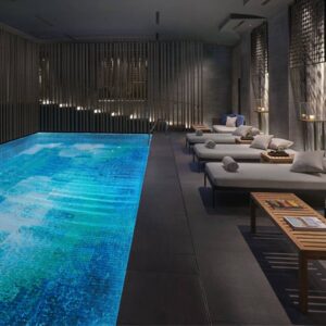 Thousands of glass tiles glisten in the light and create a mesmerizing effect in the abstract mosaic swimming pool by MEC.