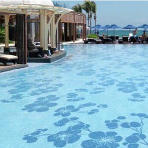 Swimming pool with an elegant display of glass tiles inspired by Victorian floral patterns by MEC.