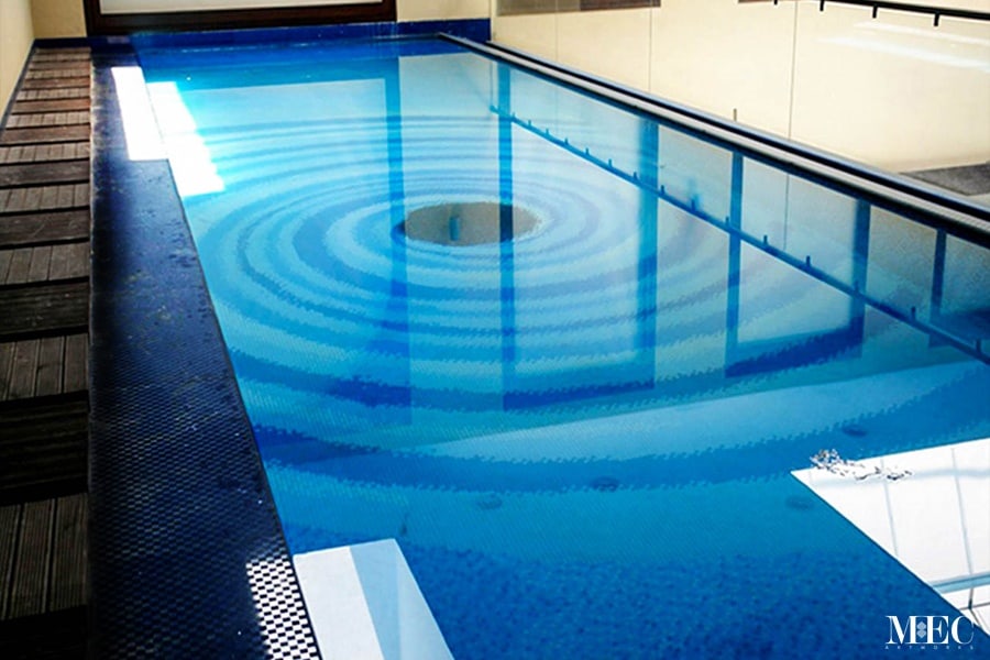 Custom Mosaics by MEC | Whirlpool glass mosaic pool design made with blue & black glass tiles.