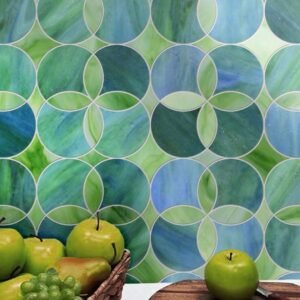 Cirkle. A product image showing Jade Glass waterjet cut tiles from Lavande collection. Custom green and blue tile design from MEC.