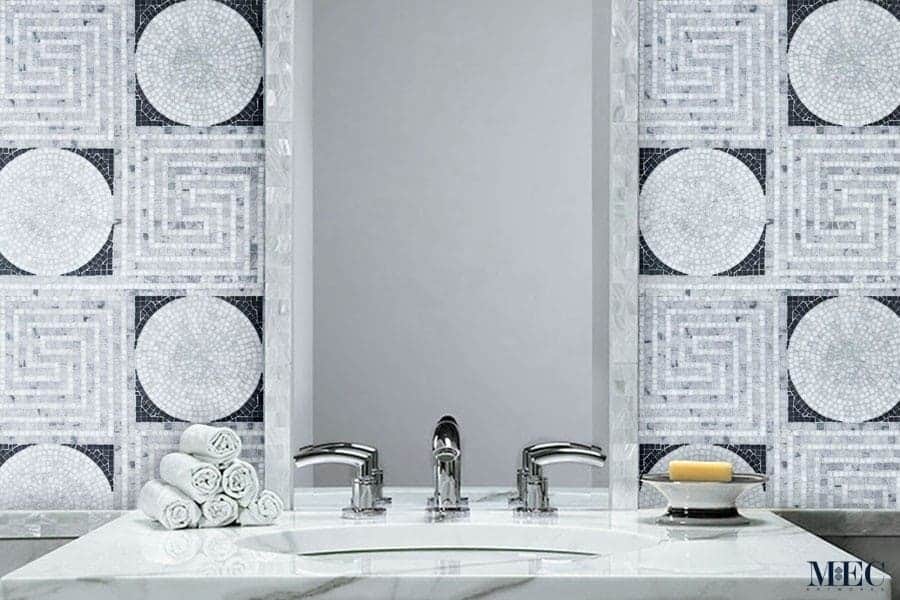 Greco | Marble tile pattern with alternating squares of labyrinth like intricate greek scroll and a solid circle.
