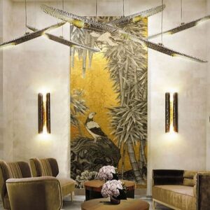 Custom Mosaics MEC | Wall ornament with birds and tree branches featuring 24K gold leaf glass tiles.