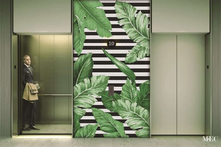 Product image. Tropica PIXL flora contemporary glass mosaic mural featuring tropical leaves, The lush green leaves add a pop of delicate color in contrast with a black and white striped background.