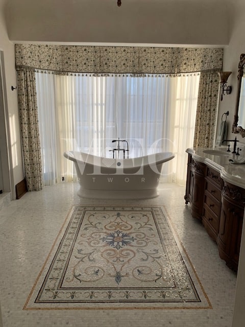 A beautiful bathroom with the customzed tore roman floor mosaic. 