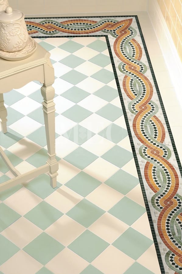 Close up of a tiled floor, featurinf checkered floor and hand crafted marble mosaic border