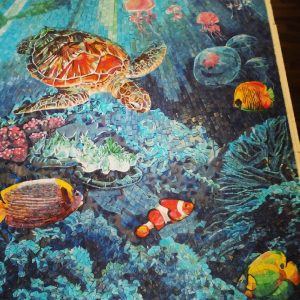 glass mosaic coral reef tropical fish underwater scene with turtle and rays of sunlight