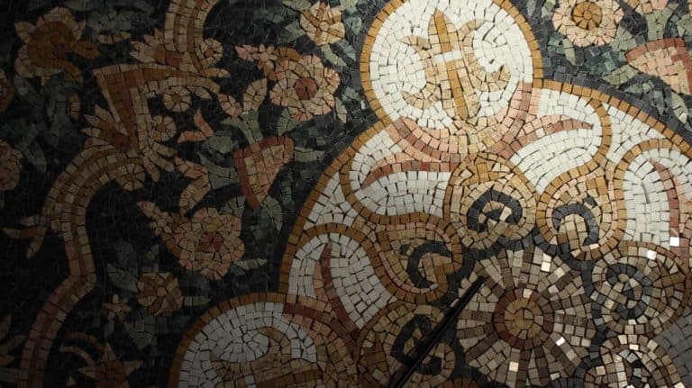 close up of a marble mosaic floor design made with polished tiles