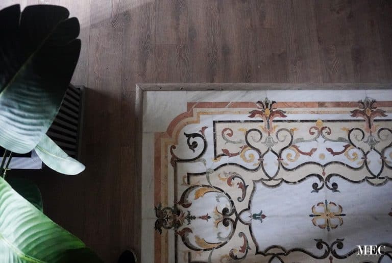 MEC floor mosaic with floral scrolls and patterns. Luxurious and artistic interior detail.