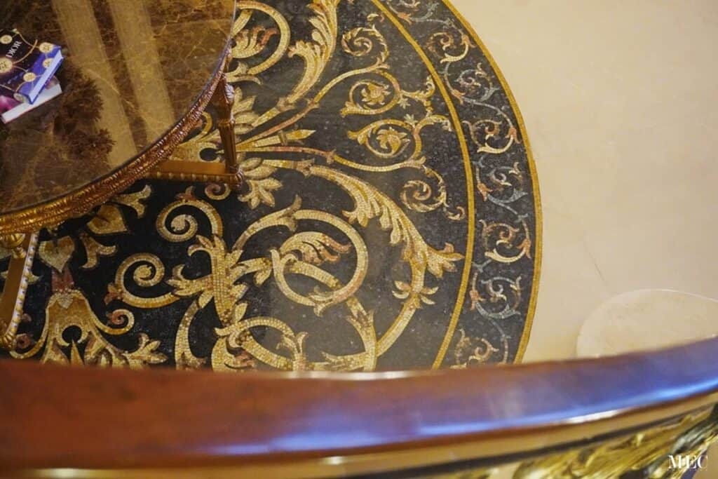 marble mosaic black and gold flooring round rug hand cut custom design close up