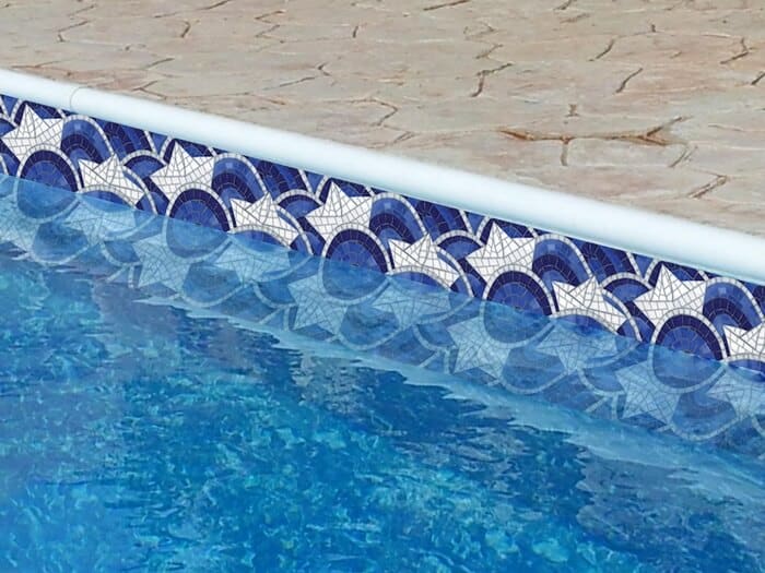 Enhance your swimming pool with a playful blue and white paper boat mosaic tile border ideas pattern crafted by MEC