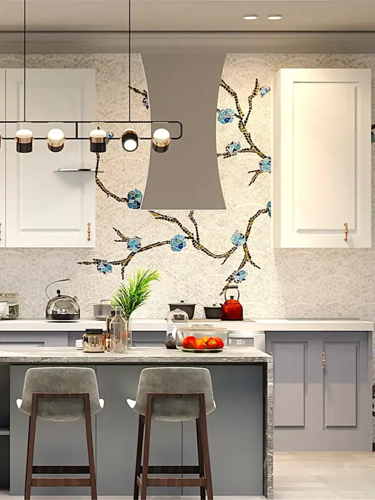 Modern kitchen with floral mosaic backsplash, marble island, pendant lighting, and two velvet bar stools.