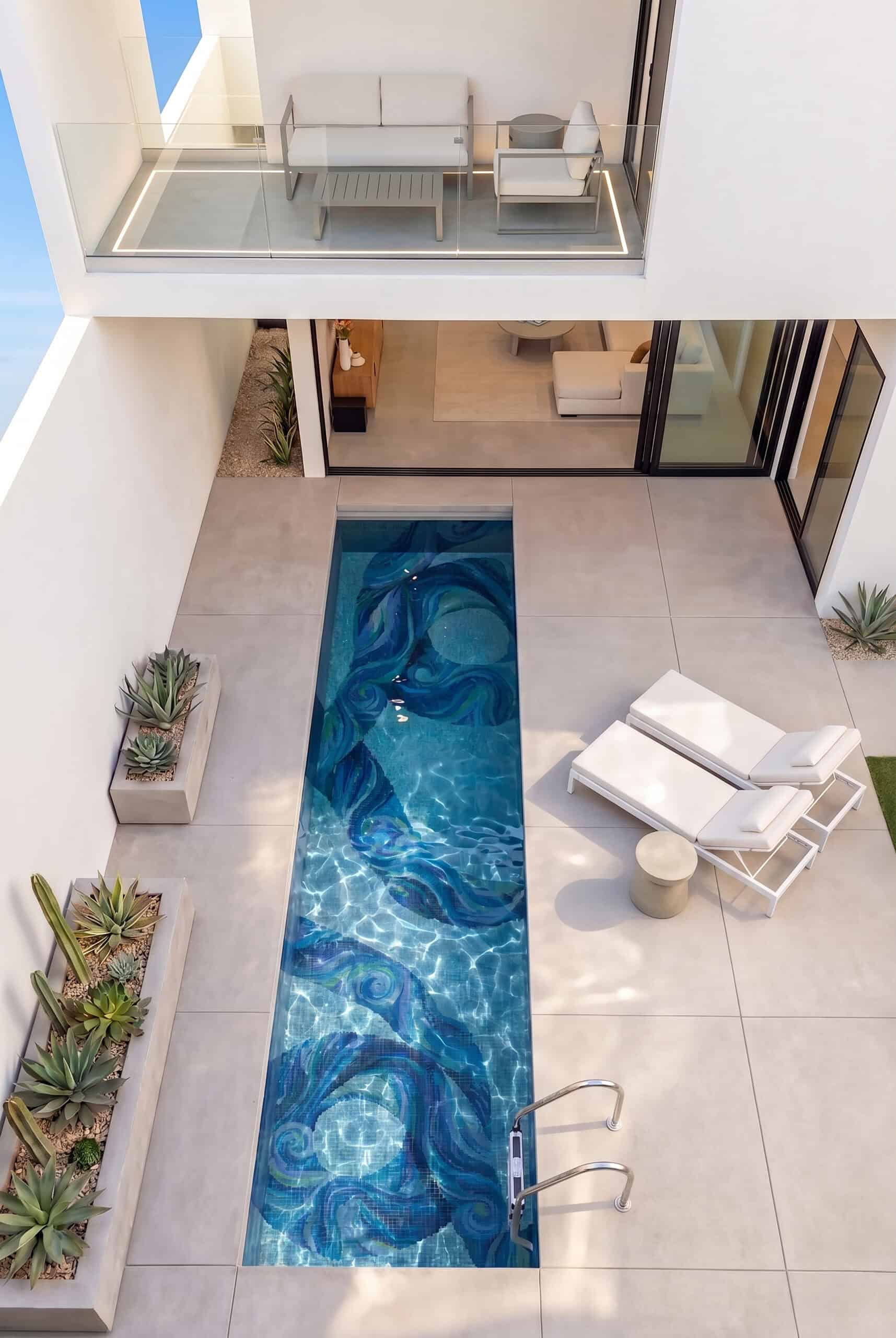 Outdoor swimming pool with abstract blue mosaic tile pattern, modern beige walls, and natural light creating a calm and artistic space.