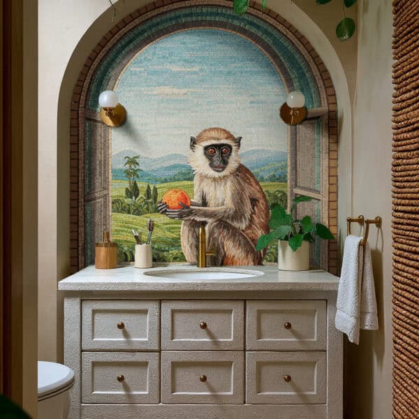 Bathroom vanity with an arched mosaic mural depicting a monkey holding a fruit against a lush tropical landscape, framed by natural textures and brass accents.
