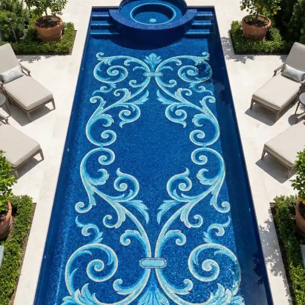 Blue pool mosaic with symmetrical scroll pattern in aqua and white, classic ornamental design on deep blue tiled pool floor.