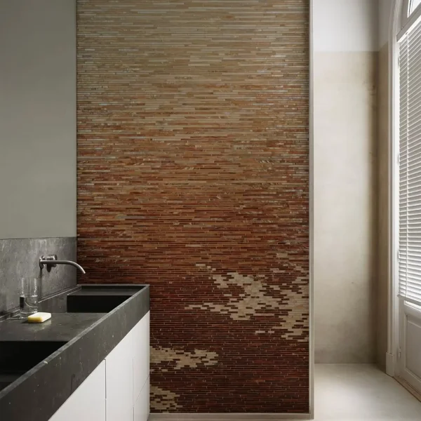 Warm ombre linear mosaic wall with slim horizontal mosaic tiles fading from beige to deep brown, earthy feature wall design for modern bathrooms.