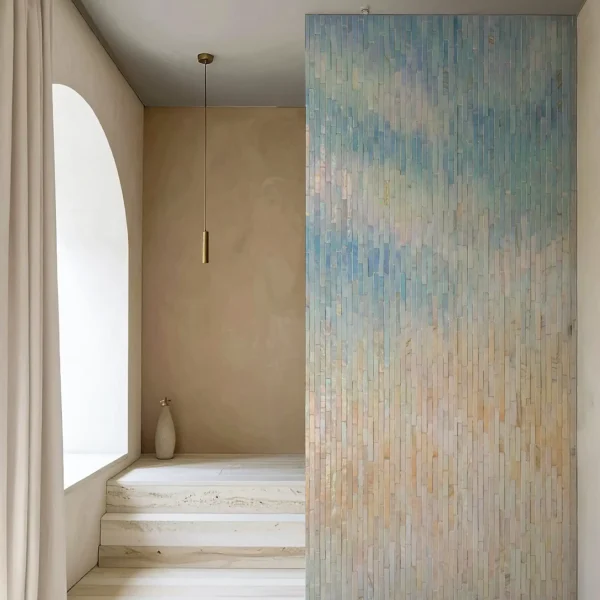 Vertical stick mosaic wall with ombre gradient from warm beige and peach to soft sky blue, modern feature wall tile design.