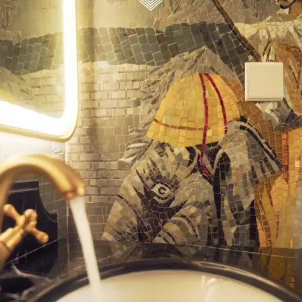 Handcrafted Elephant Mosaic Wall Design elephant mosaic wall art in bathroom with glass and stone tiles, neutral tones and golden accents, perfect for luxury interiors and feature walls