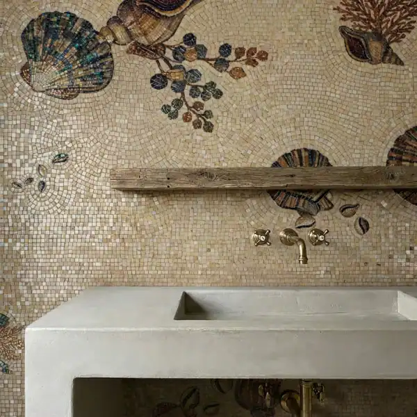 Mediterranean Shell Mosaic vanity wall with beige seashell mosaic design, brass fixtures, and warm coastal tones.