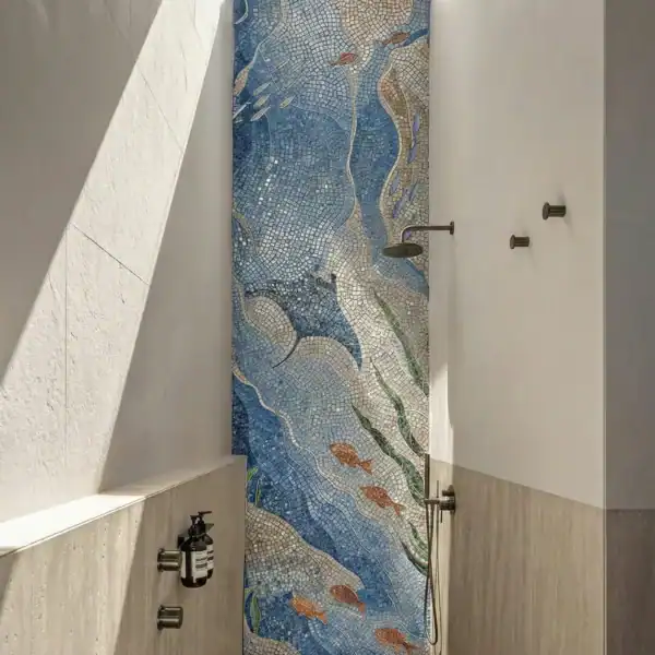 Tidal Depth Mosaic Wall Tidal Depth Marine Mosaic shower wall with flowing blue mosaic bands and fish detailing in a modern spa-style bathroom.