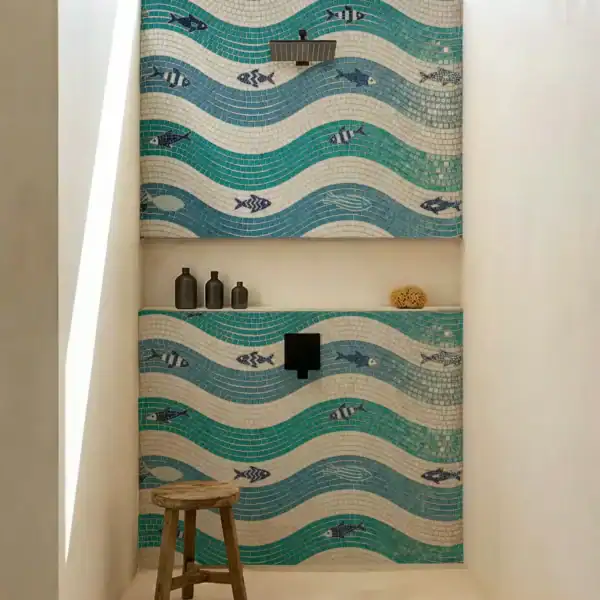 Tidal Rhythm Bathroom Mosaic Wall Tidal Rhythm bathroom mosaic used as a shower feature wall with turquoise wave-pattern mosaic and blue fish detailing.