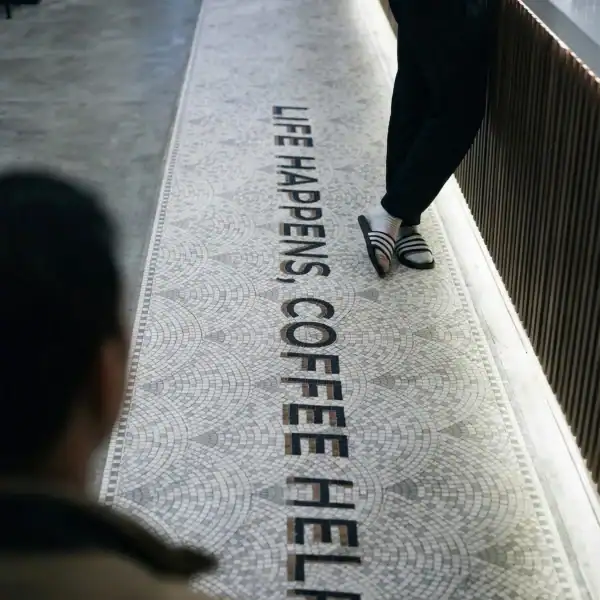 Modern Script Statement Mosaic Runner life happens coffee helps mosaic floor with modern typography and grey pattern, ideal for cafes, restaurants, walkways, and hospitality interiors