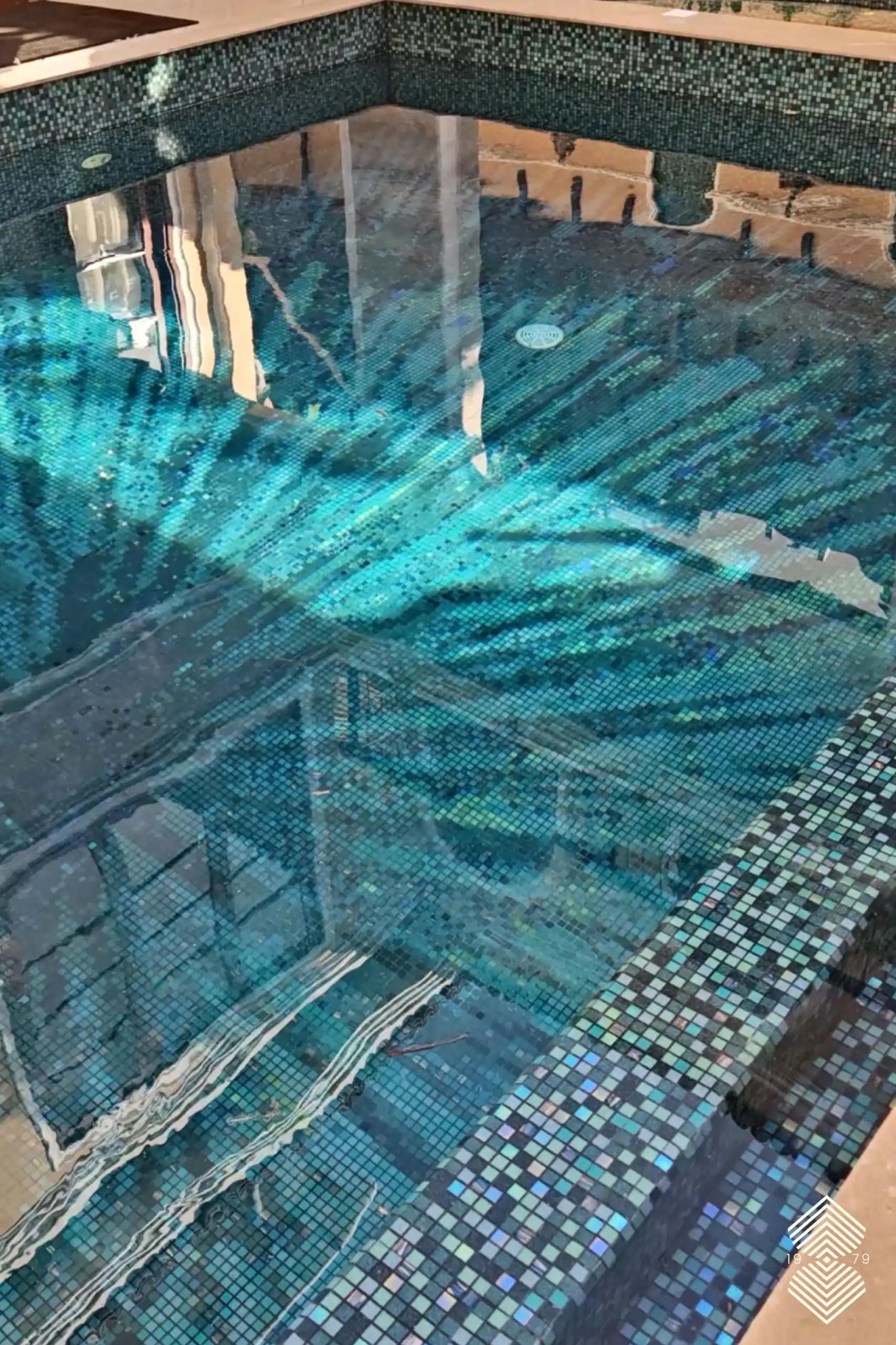 aqua mosaic tiles with pool featuring shimmering ocean-inspired patterns and reflective underwater textures