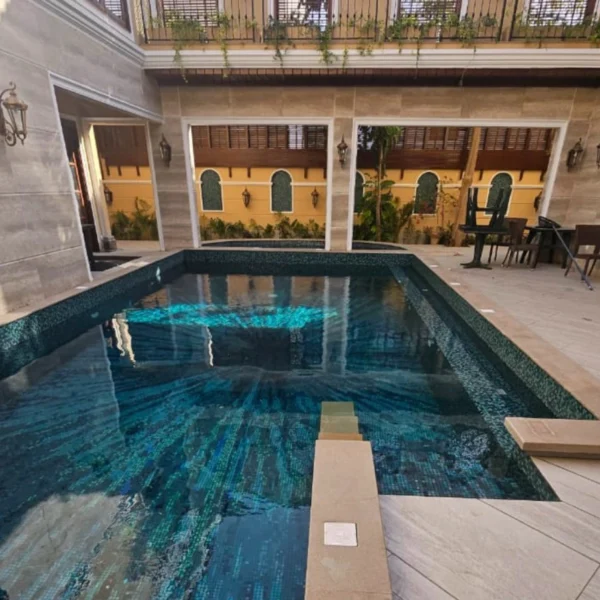 Abyss Tide Mosaic Pool luxury swimming pool with blue aqua mosaic tiles featuring shimmering ocean-inspired patterns and reflective underwater textures