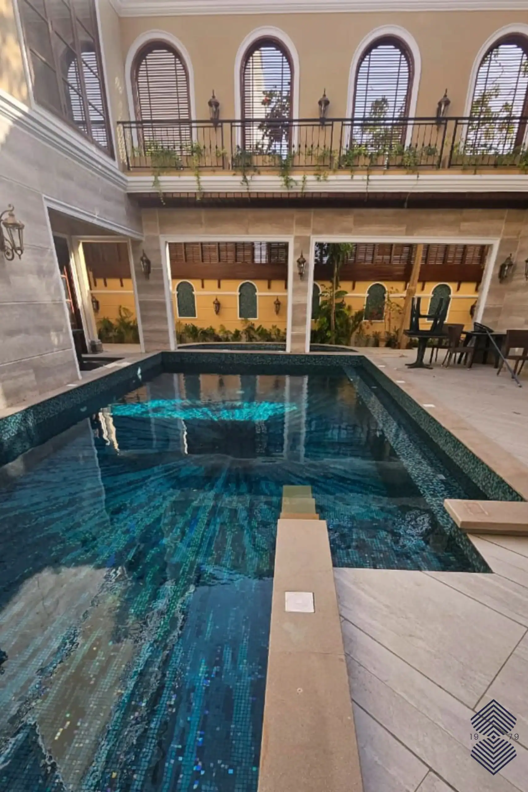 luxury swimming pool with blue aqua mosaic tiles featuring shimmering ocean-inspired patterns and reflective underwater textures