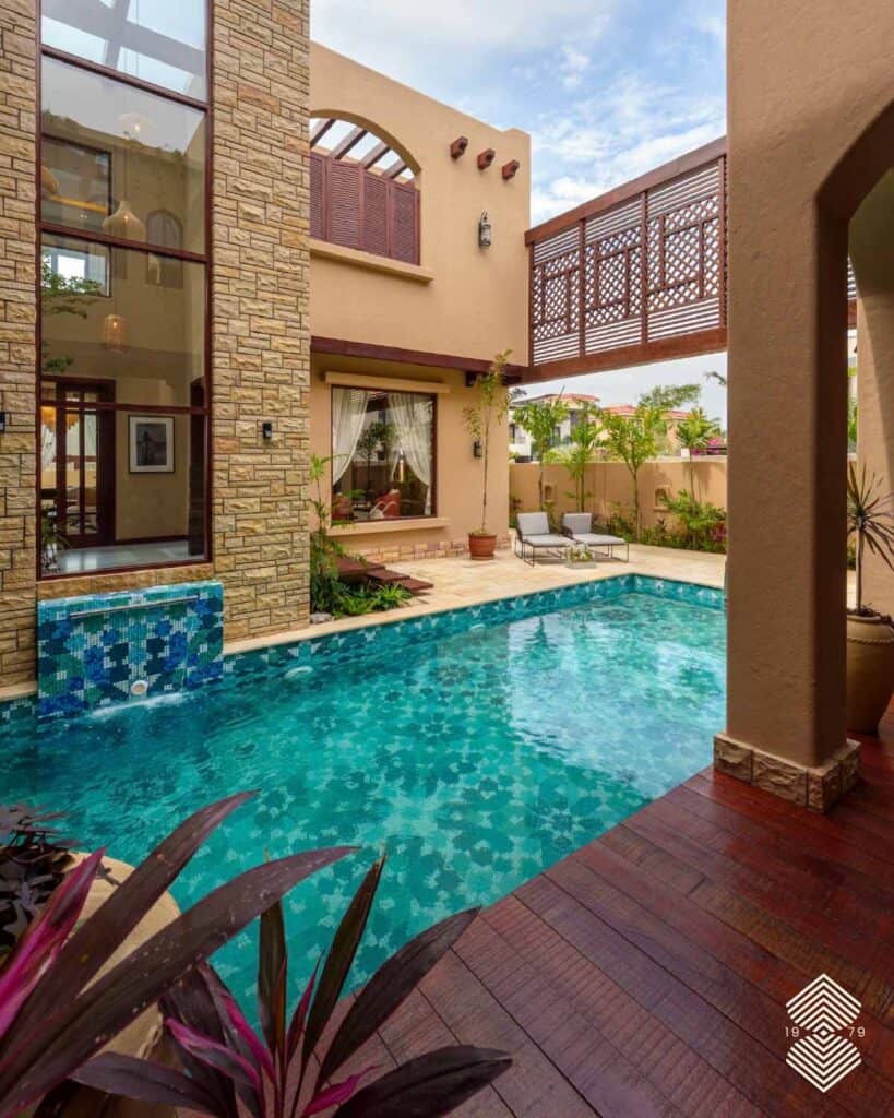 Custom glass pool tiles with geometric Moroccan design for luxury resort