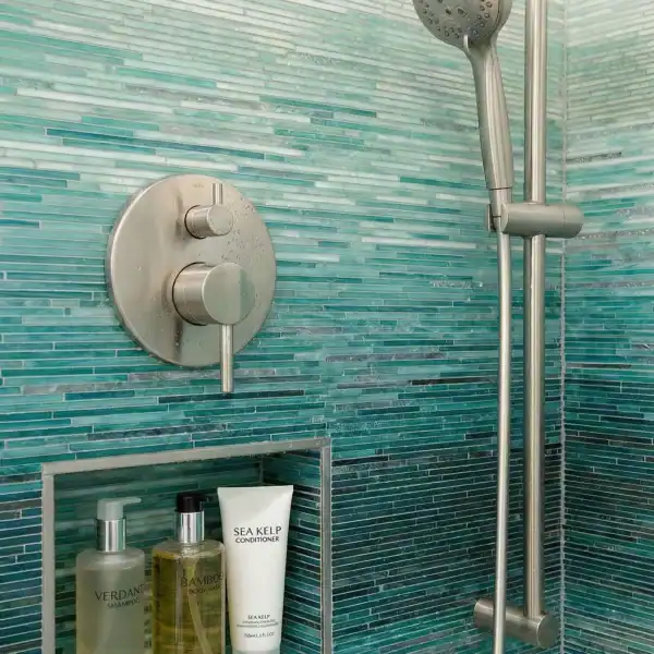 Laguna Tide Ombre Glass Mosaic turquoise linear glass mosaic shower wall with glossy aqua gradient tiles creating a modern spa-inspired bathroom interior