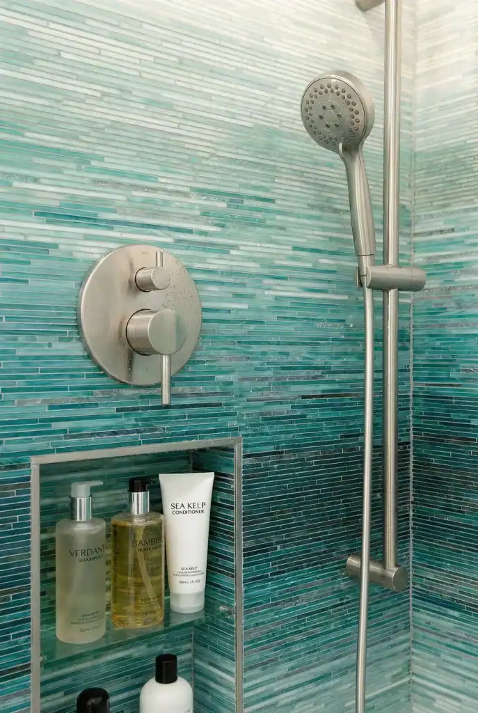 turquoise linear glass mosaic shower wall with glossy aqua gradient tiles creating a modern spa-inspired bathroom interior