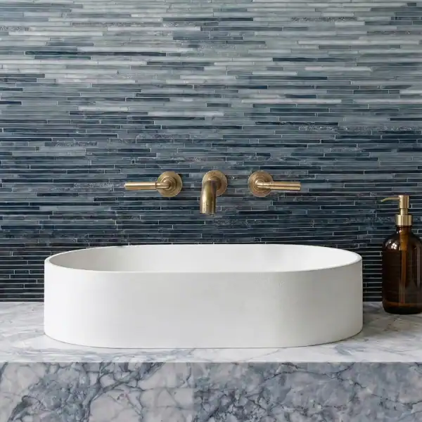Storm Blue Ombre Bathroom Mosaic dark blue linear glass mosaic backsplash with gradient tones behind modern white sink in luxury contemporary bathroom interior