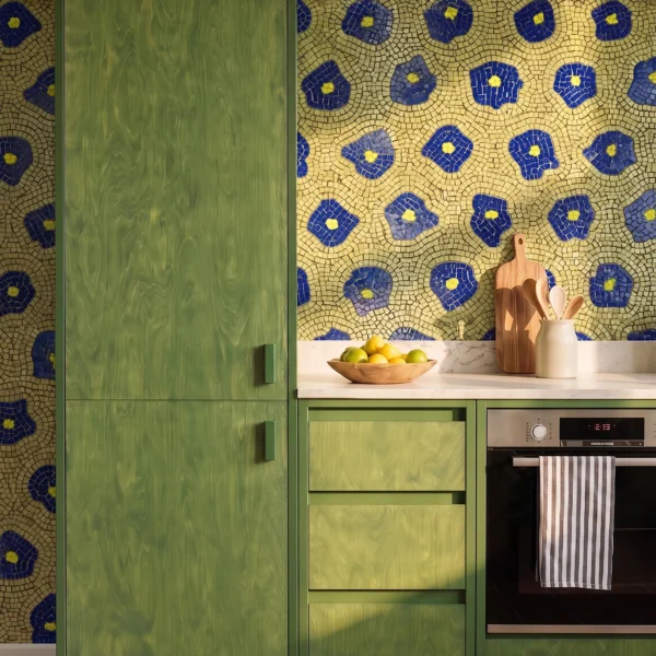 The Aurelian Bloom blue floral mosaic backsplash with handcrafted Mediterranean pattern and green cabinetry in luxury contemporary kitchen interior