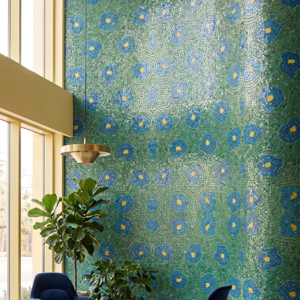 The Majestique Meadow large curved floral mosaic feature wall with blue blossoms and green botanical textures in a luxury contemporary lounge interior