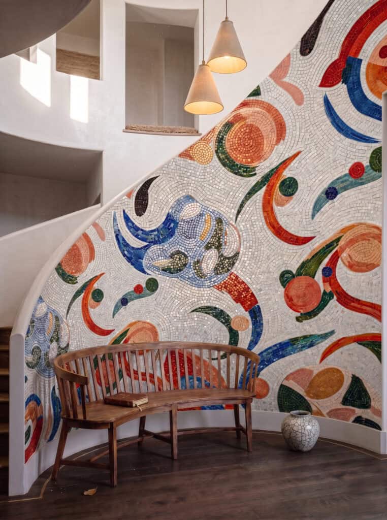 Wall Mosaic Featuring Colorful Abstract Shapes Against a Shimmering Pale Background