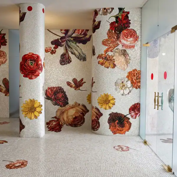 Imperial Dahlia luxury floral mosaic installation featuring dahlias, roses, and botanical blooms flowing across walls and columns on an ivory mosaic background