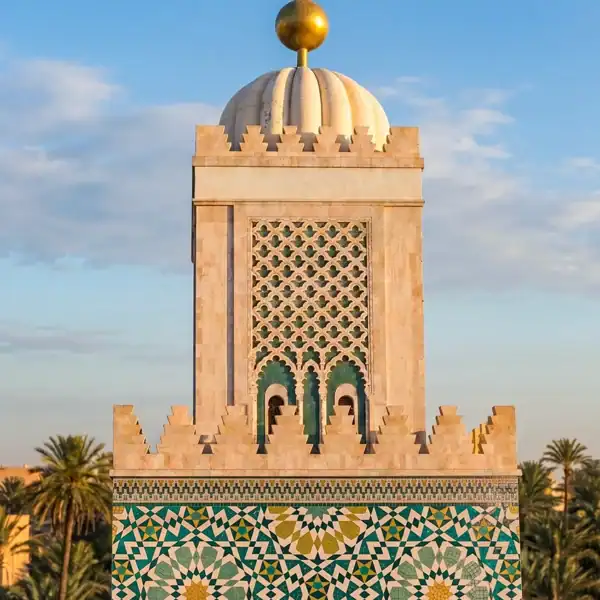 Royal Zellige Mosaic Architecture moroccan geometric mosaic tower featuring intricate islamic star patterns in turquoise gold and ivory architectural design