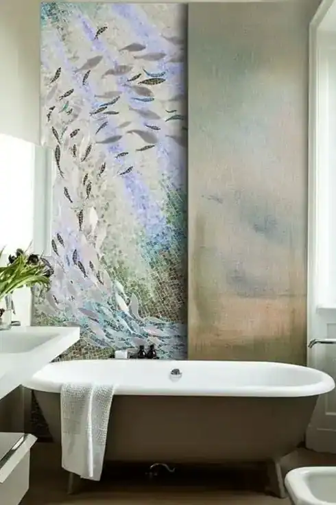 Marine mosaic artwork showcasing a calming moment of ocean life, with fishes softly swimming in light gray glass tiles with teal and cobalt shades