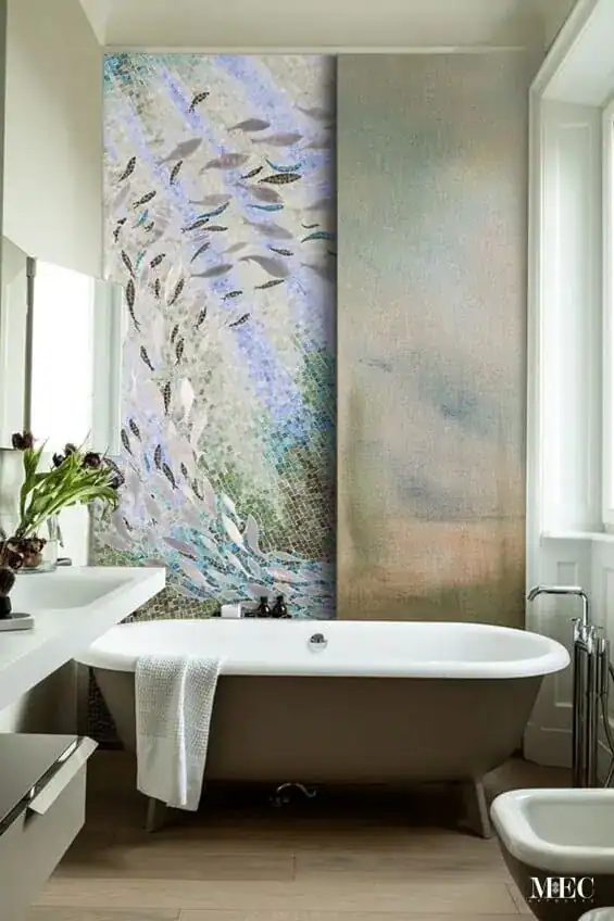 A mosaic artwork inspired by marine life, showcasing fishes gently swimming in pearl, and light gray glass tiles with teal and cobalt shades