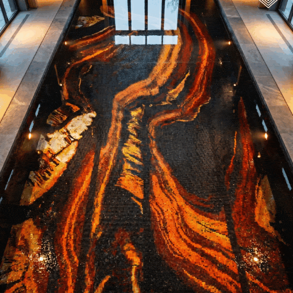 Obsidian Flare Pool Mosaic abstract pool mosaic with flowing amber, copper and gold lava-inspired patterns across a deep black handcrafted glass mosaic floor