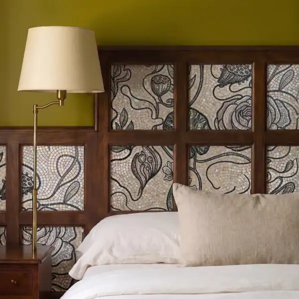 Opaline Rosetta handcrafted botanical mosaic headboard featuring flowing vines, floral motifs, and charcoal stone tesserae framed within wooden panels