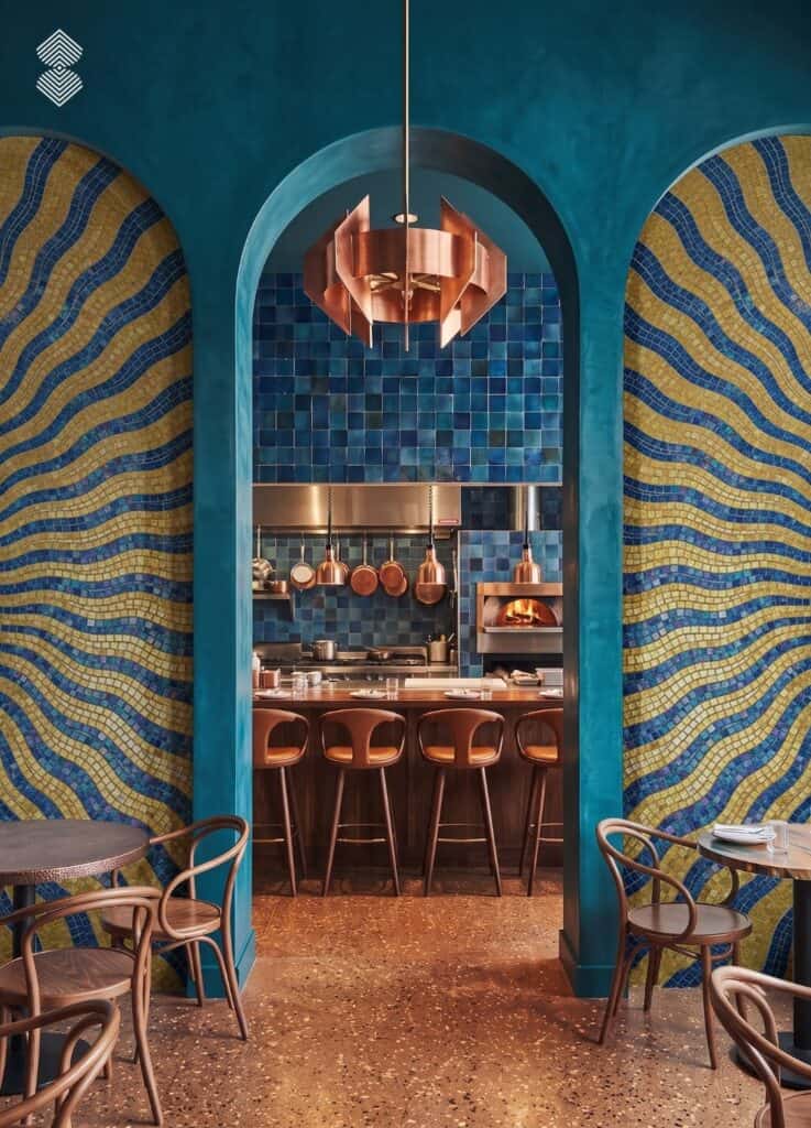Decorative mosaic backsplash tile behind a contemporary café counter