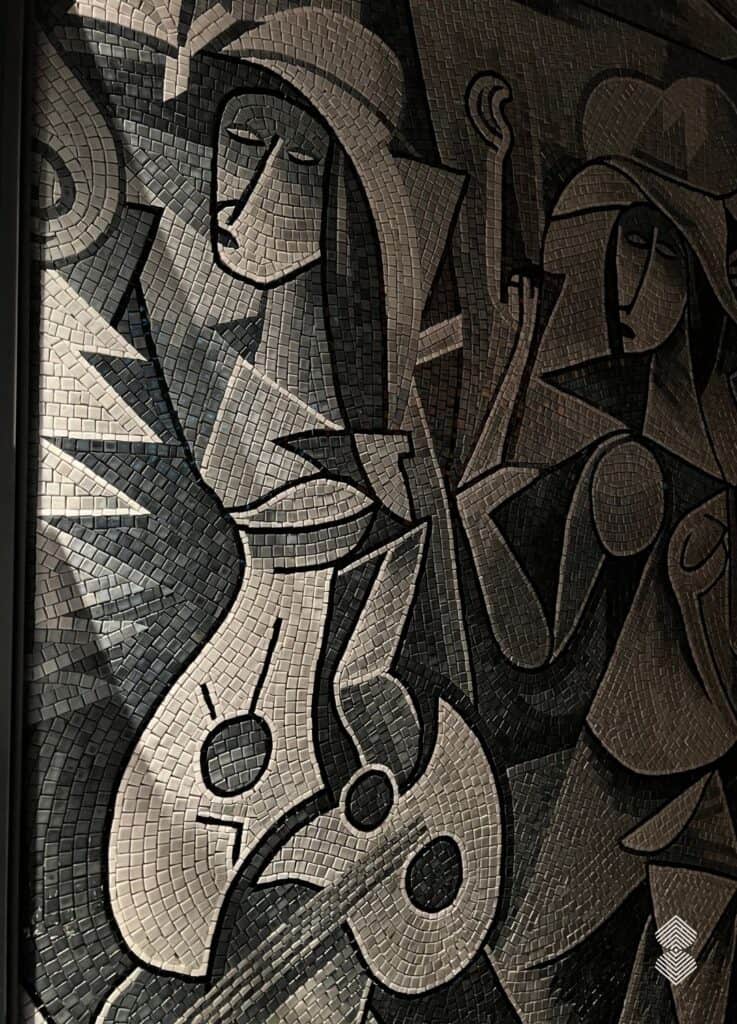Mosaic wall art displayed in a café restroom niche