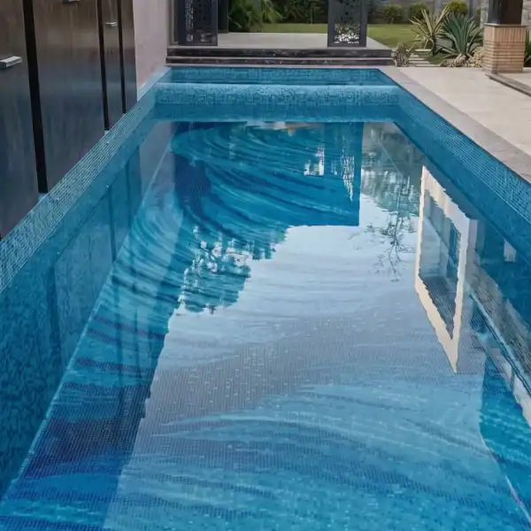 Lumina Obscura Lumina Obscura Mosaic features flowing aqua, turquoise and deep blue glass mosaic bands across a luxury contemporary swimming pool.