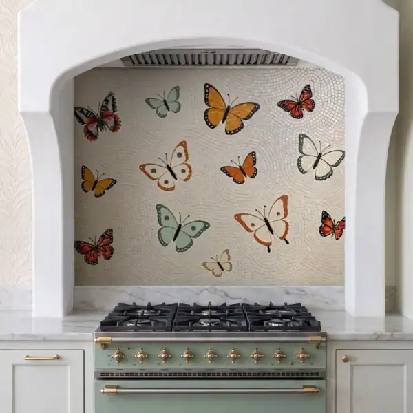 The Chrysalis The Chrysalis Mosaic features colorful butterflies in orange, sage, cream and red tones across a soft ivory handcrafted mosaic kitchen backsplash.