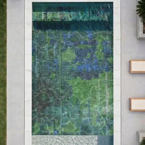 The Verdigrisia The Verdigrisia Mosaic features layered emerald, teal and deep blue glass mosaic tones creating an abstract artistic design across a luxury swimming pool.
