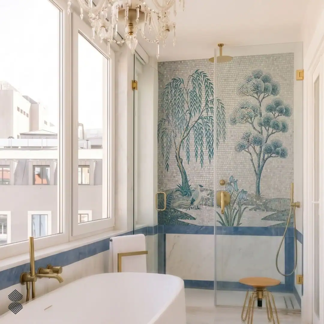 Willowmere mosaic shower wall with teal willow trees, botanical foliage and a white bird, handcrafted in premium glass and marble mosaic tesserae.